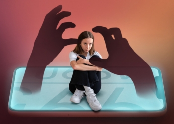 Pensive young attractive girl reading book and sitting on chair